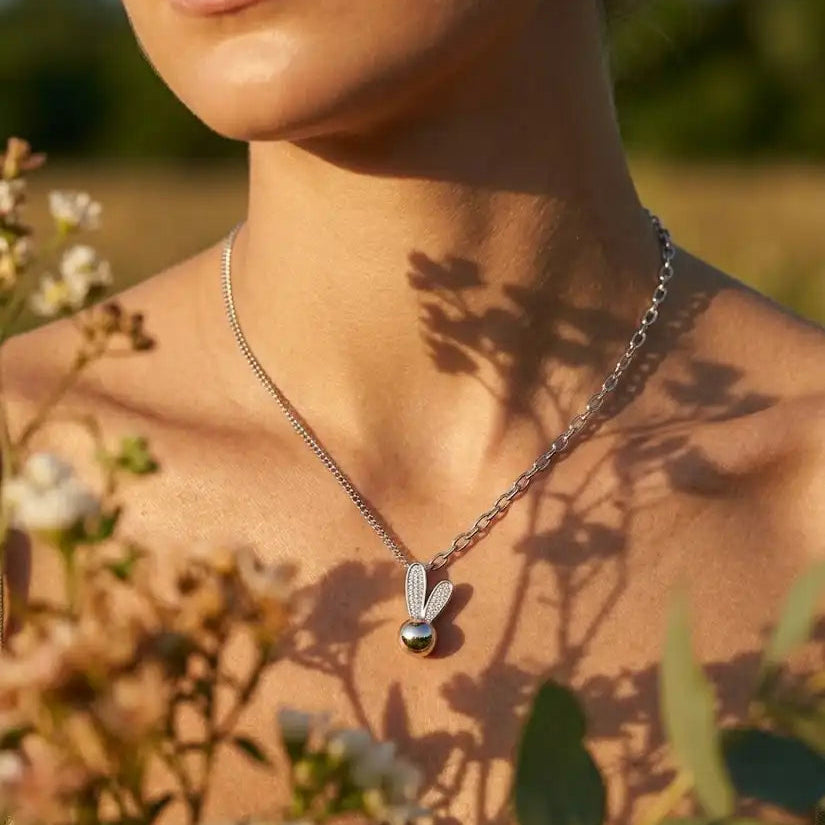 Necklace with a pendant worn by a person in a natural setting